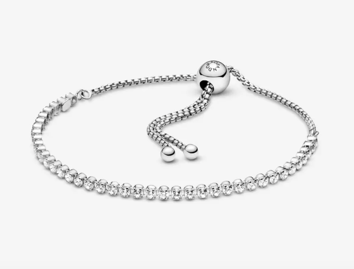 Bracelet en argent sterling orné d'oxydes de zirconium cubiques transparents et d'un fermoir coulissant phosphorescent.